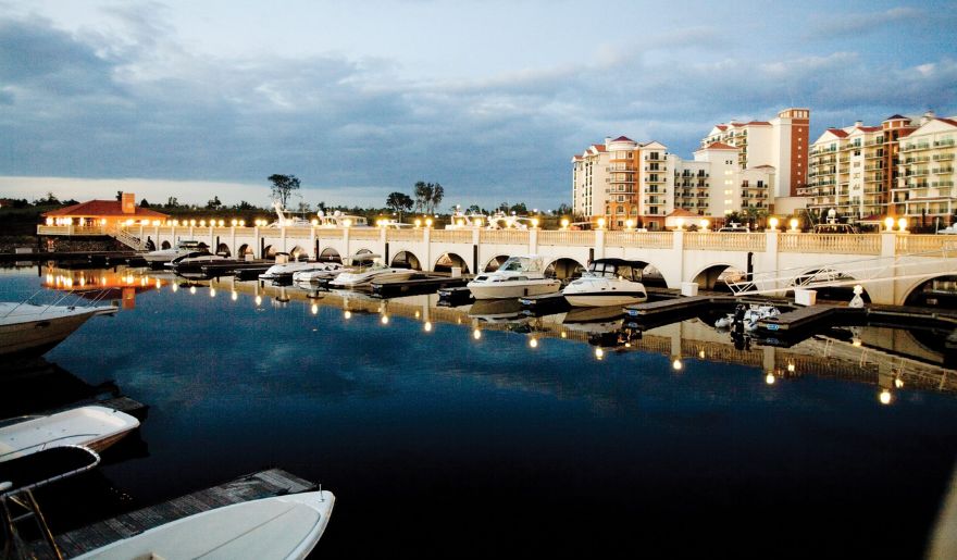 The view of Marina with boats and buildings during night time