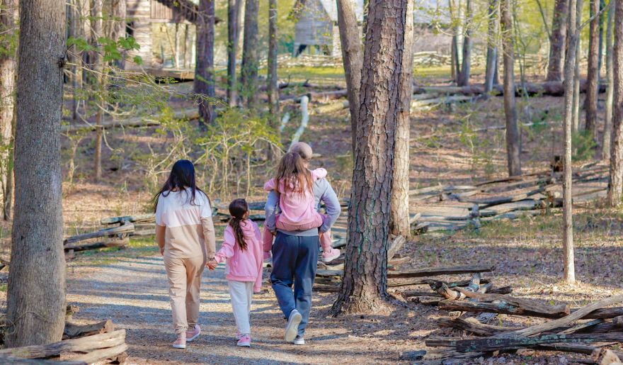 A family of tourist walking in the forest at Myrtle Beach State Park