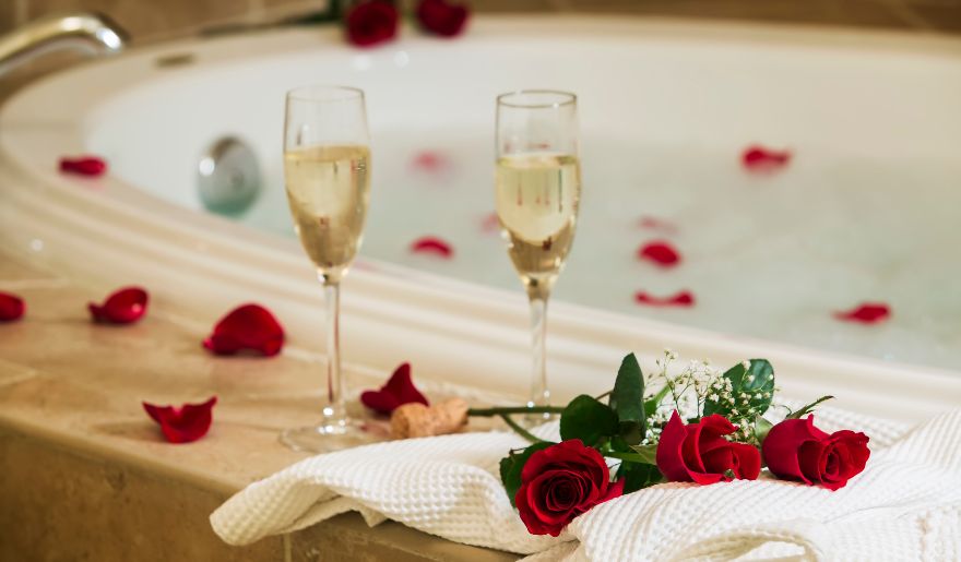 Romantic jacuzzi setup with rose petals and champagne, ideal for couples on a Myrtle Beach romantic getaway