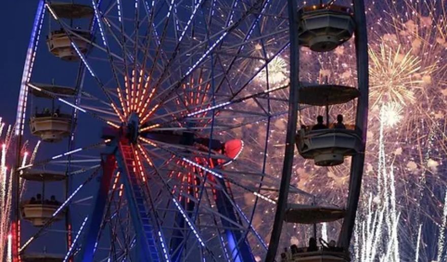 Night time view of Ferris Wheel with fire works in Family Kingdom Amusement Park