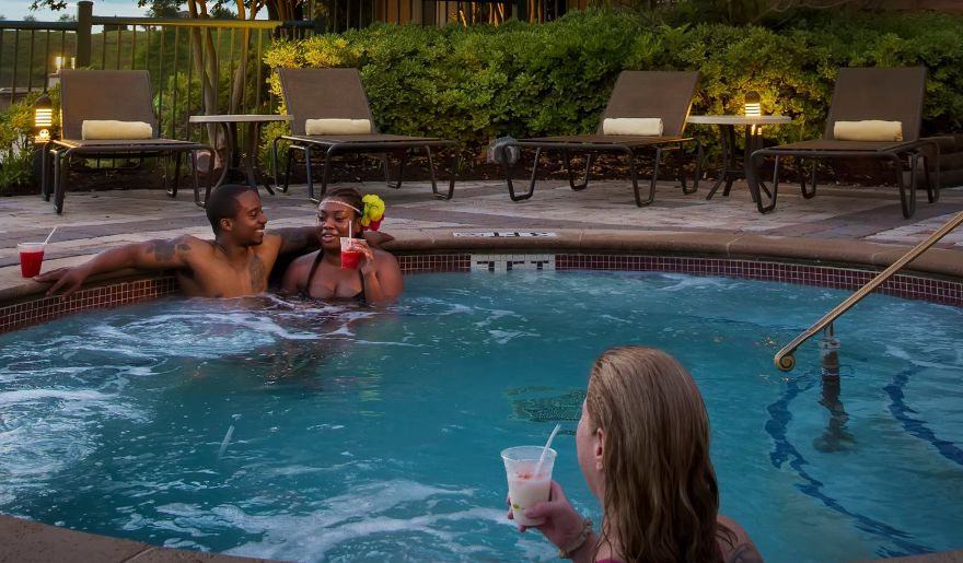 Couples enjoying a relaxing evening in the outdoor hot tub at Marina Inn at Grande Dunes, a highlight for a Myrtle Beach romantic getaway.