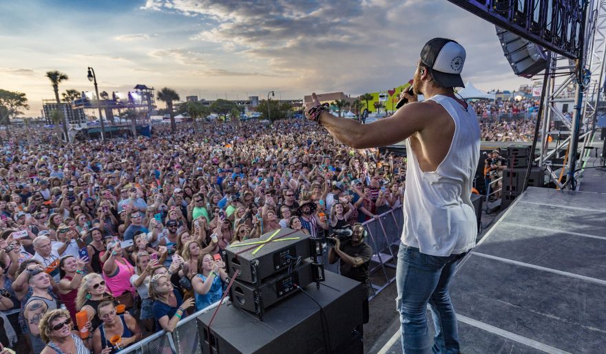 A musician perform at Carolina Country Music Fest with many participants