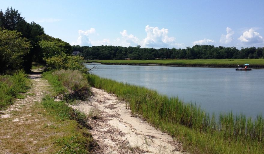 A picturesque hiking path beside the river, offering a serene experience in the Heritage Shores Nature Preserve area.