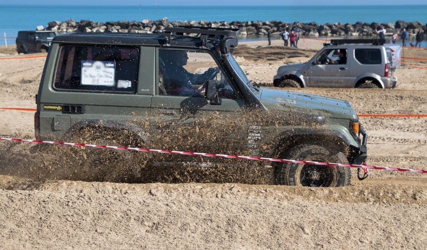 A jeep traversing the beach sand at Myrtle Beach, showcasing the excitement of the October Jeep Jam event.