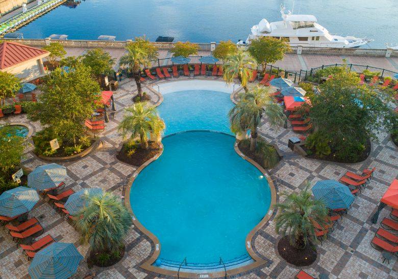 The inviting pool area at the Marriott Orlando Riverfront Hotel, surrounded by lush landscaping and luxury amenities.
