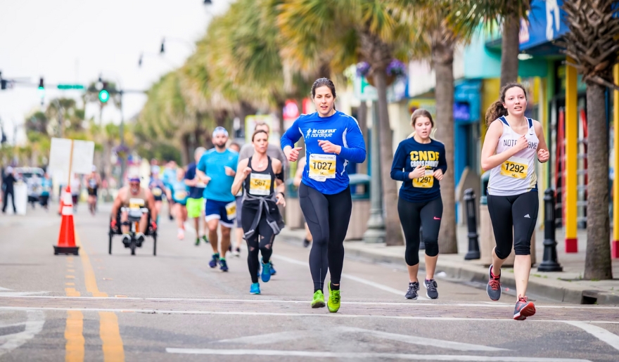 A lively scene of marathon runners, representing the excitement of spring events and festivals in Myrtle Beach.