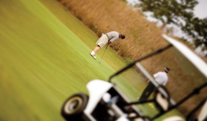 A group of tourist playing golf on a vibrant green field, reflecting a fun Myrtle Beach bachelor party.