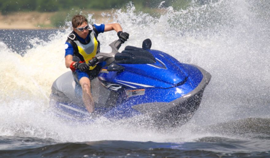 A man enjoys riding a jet ski on the water, highlighting the thrill of beach activities during a Myrtle Beach bachelor party.