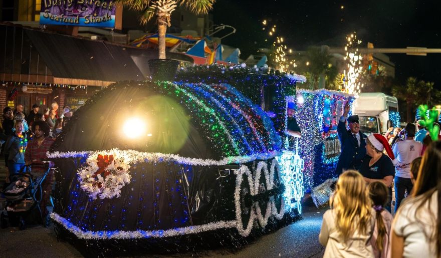 A vibrant parade float adorned with colorful lights and festive decorations, showcasing the holiday spirit in North Myrtle Beach.