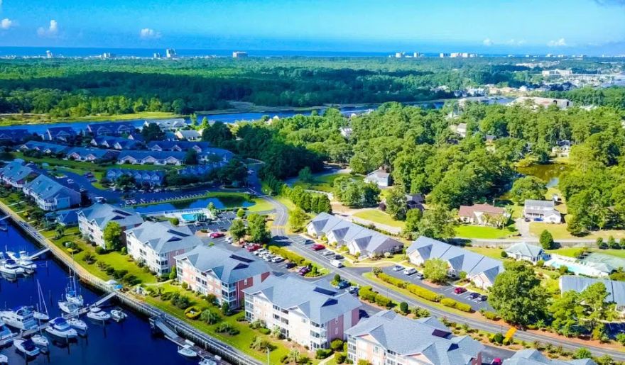 Aerial view of a the Intracoastal Waterway with homes along the water, showcasing the scenic beauty of Myrtle Beach.