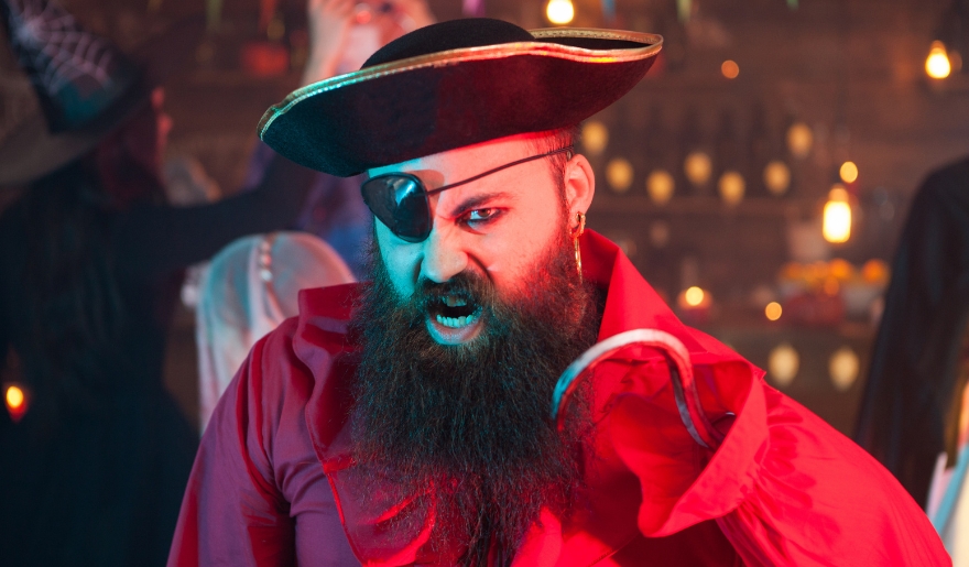 A bearded man in a pirate hat, showcasing the festive spirit of the Pirates Voyage Dinner & Show in Myrtle Beach.