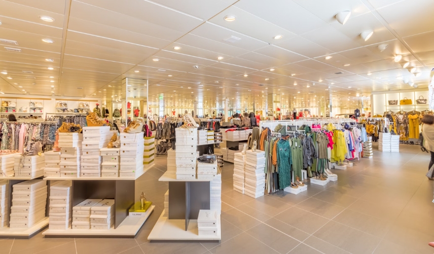 Interior of a spacious store showcasing a wide selection of clothing and accessories at Myrtle Beach's Coastal Grand Mall.