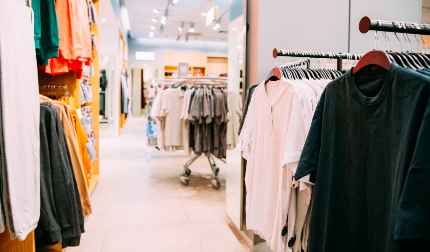 Interior of a clothing store in North Myrtle Beach, showcasing clothes hanging on racks for customer browsing.