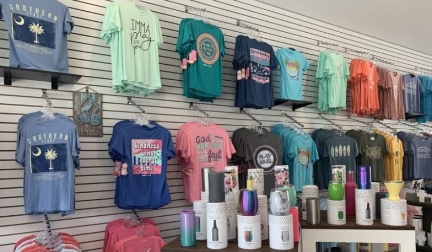 A vibrant store displaying a variety of shirts and merchandise, showcasing Myrtle Beach's shopping allure on the Shops on Main.