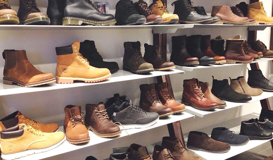 An extensive array of boots displayed on shelves, highlighting the shopping options at Myrtle Beach's Main Street.