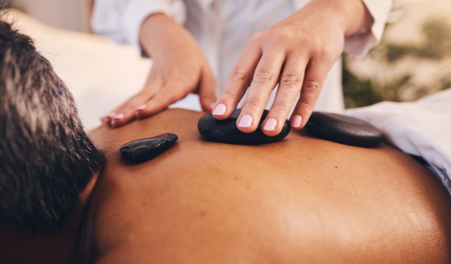 Man enjoying a soothing back massage at a spa, embodying wellness and relaxation during his Myrtle Beach bachelor party.