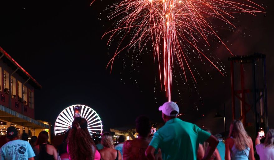 A lively audience admires the dazzling fireworks, celebrating New Year's Eve at Broadway at the Beach.