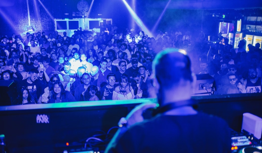 A DJ entertains a vibrant crowd at Tin Roof Myrtle Beach for New Year’s celebrations.