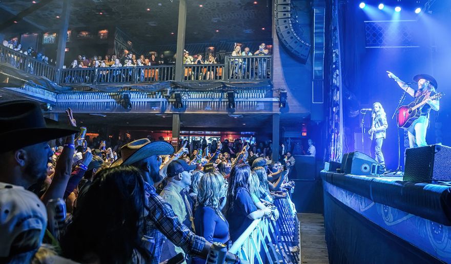 A vibrant crowd enjoying a live concert at the House of Blues in Myrtle Beach, showcasing music and entertainment.