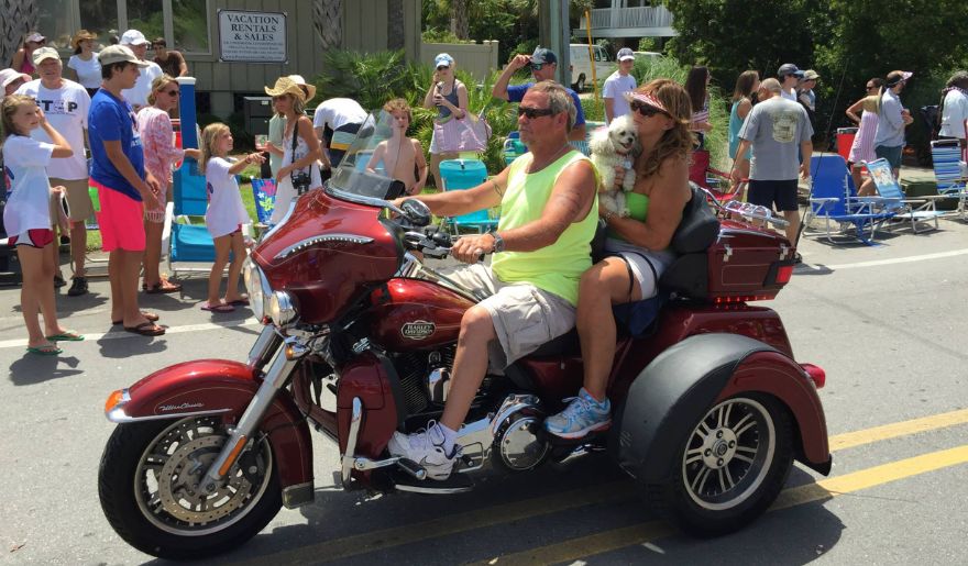 A couple rides a motorcycle along a scenic coastal drive in Pawleys Island.