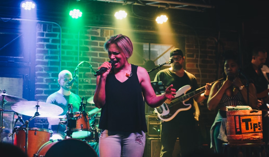 A woman singing with a band on stage at Myrtle Beach Spring Break, capturing the essence of vibrant nightlife and entertainment.