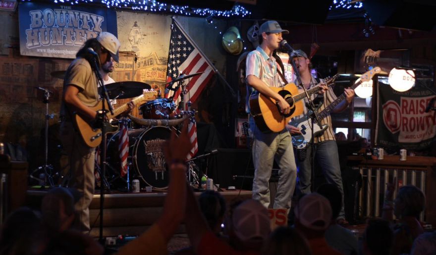 A lively band performs at The Bowery in Myrtle Beach, with an enthusiastic crowd enjoying the Spring Break atmosphere.