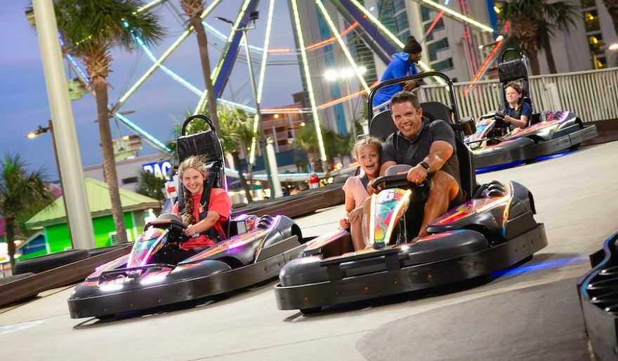 A family races go-karts at Myrtle Beach, creating fun memories together during their spring break vacation.