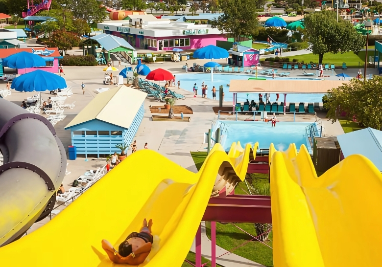 A vibrant water park at an affordable family resort in Myrtle Beach, featuring a large slide and a refreshing pool.