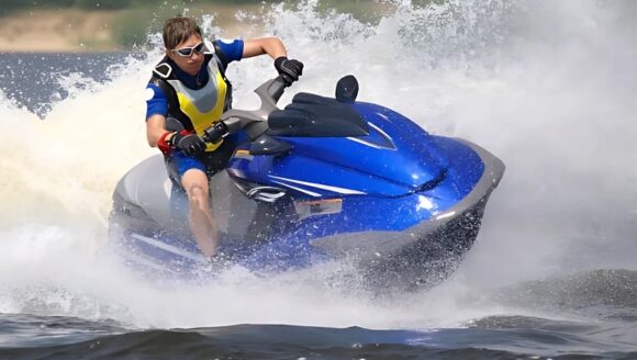 A man enjoys riding a jet ski on the water at an affordable family resort in Myrtle Beach.