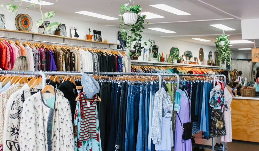 A clothing store at Barefoot Landing, featuring racks and shelves filled with various apparel for shoppers.