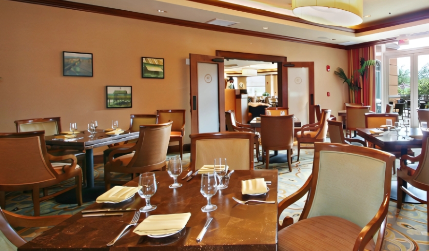 A restaurant interior featuring tables and chairs centrally arranged, highlighting dining options at Waterscapes Restaurant.