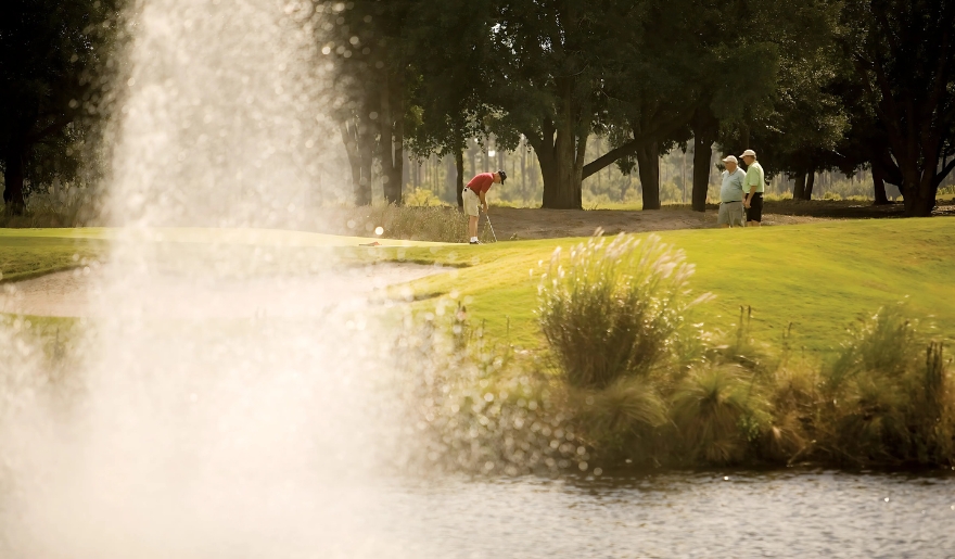 A man and woman enjoy a game of golf at Marina Inn, Myrtle Beach Golf Courses.