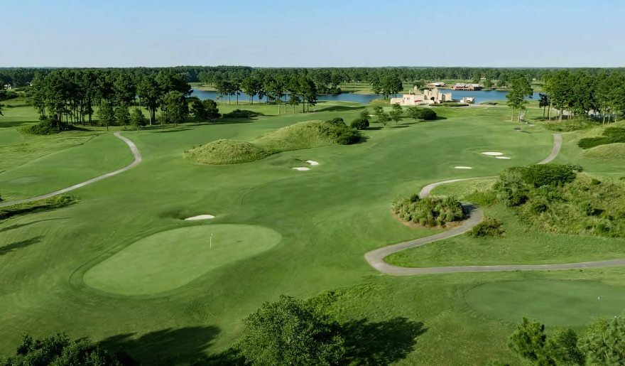 The Wizard Golf Club in Myrtle Beach, displaying a beautiful golf course with a lake, surrounded by lush greenery.