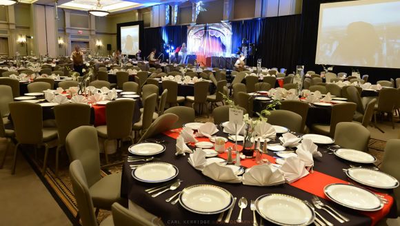 A beautifully set banquet hall at Marina Inn, ready for a dinner with tables and chairs arranged for guests.