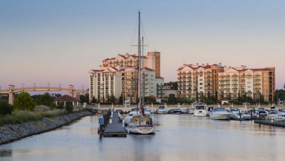 A marina at sunset with boats docked, showcasing the Honeymoon Suites at Myrtle Beach, SC, perfect for romantic cruises