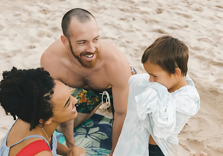 A joyful family of three at Myrtle Beach, with a man, woman, and child creating memories on the sandy beach.