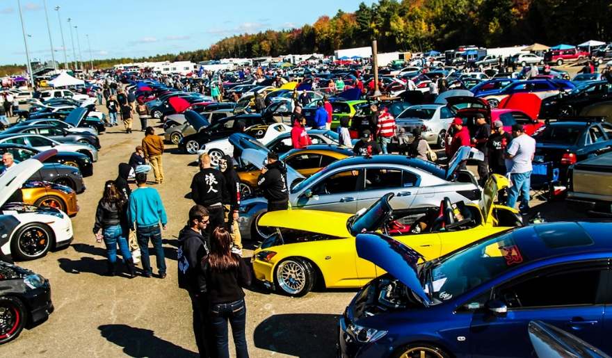 A large crowd gathers around various cars at the Myrtle Beach Festivals – Run to the Sun Car Show.