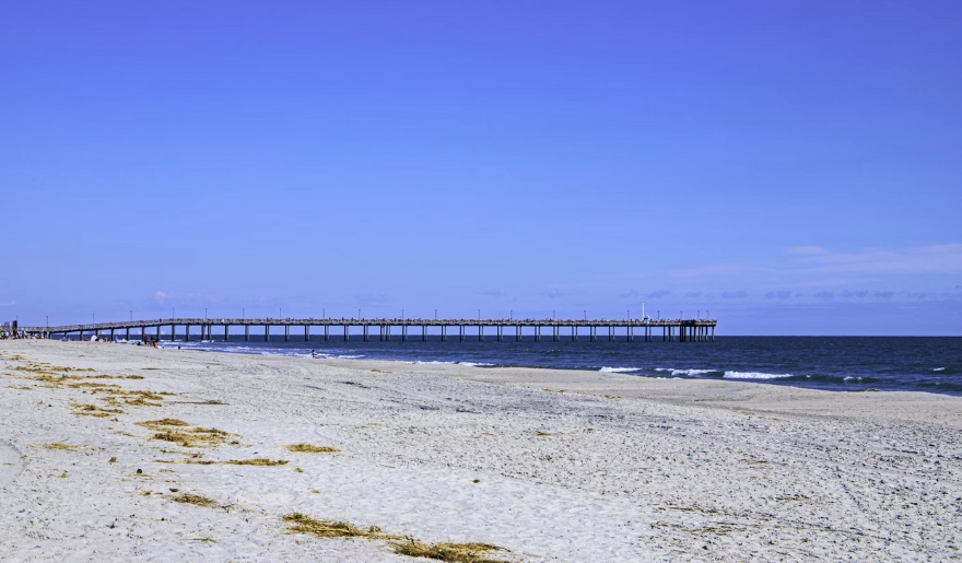 A view of Cherry Grove Pier at Myrtle Beach, with sandy shores and a festive 4th of July atmosphere.