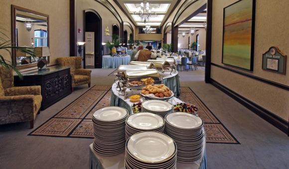 A long hallway set for Myrtle Beach Easter Brunch, featuring a buffet table and chairs arranged for guests.