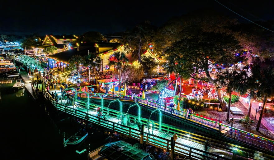 A festive boat dock adorned with Christmas lights, showcasing the MarshWalk Wonderland of Lights at Myrtle Beach Events 2025.