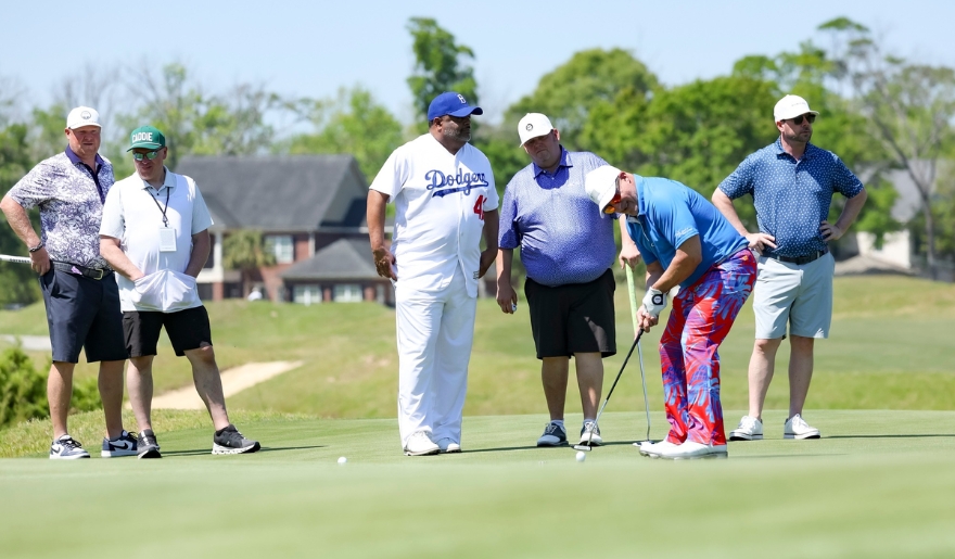 A group of men enjoying a round of golf on a lush green field during Monday After the Masters Event, at Barefoot Resort in Myrtle Beach.