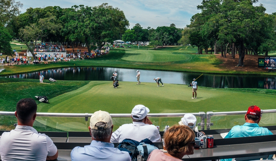 Attendees at the Myrtle Beach Classic PGA tour event watch intently as golfers compete in an exciting tournament.