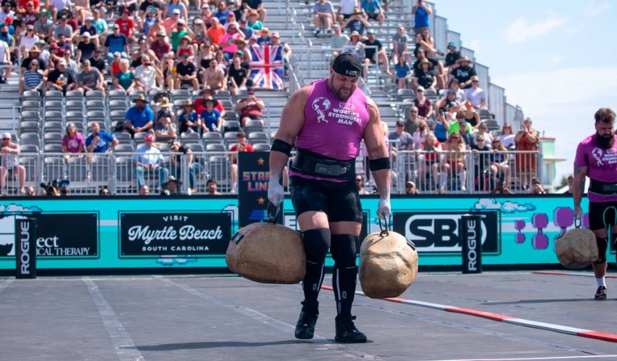 A man competes in the Myrtle Beach event, carrying two bags during the SC Strongest Man & Woman Competition.