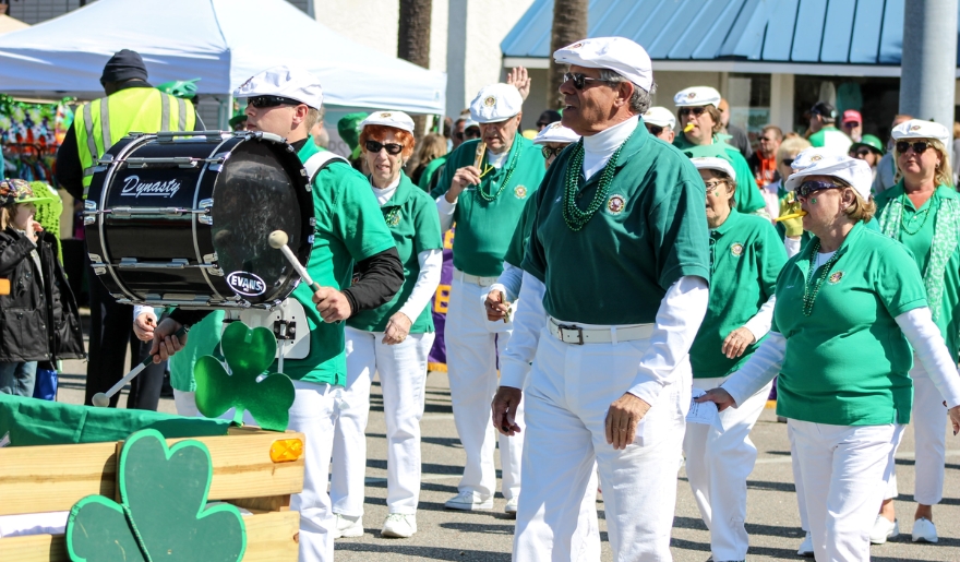 A group of individuals wearing green shirts and white pants at the St. Patrick’s Day Parade in Myrtle Beach.