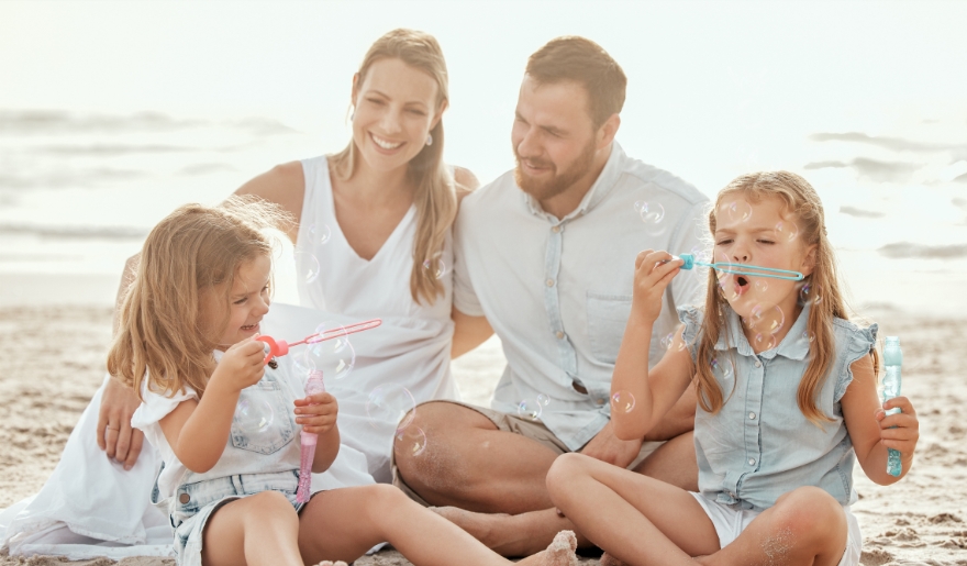 A family enjoying a beach day at Myrtle Beach, creating memories with their children during a vacation.