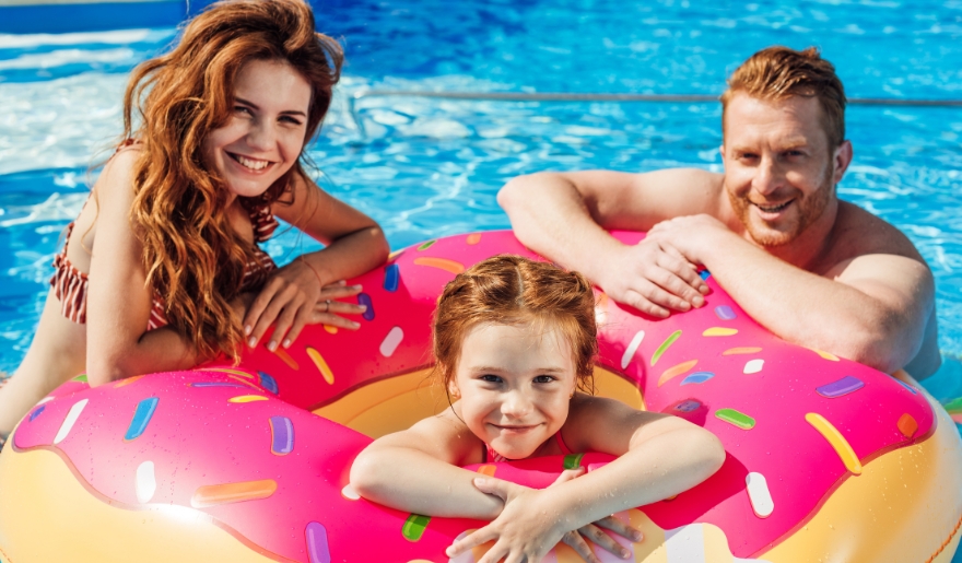 A joyful family spends the day at Myrtle Waves Water Park, having fun together at the pool.