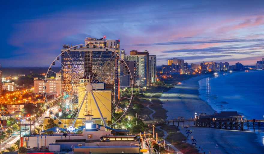 A cozy beach bonfire surrounded by family at Myrtle Beach, SC, with the Grand Strand's sandy shore and ocean view.