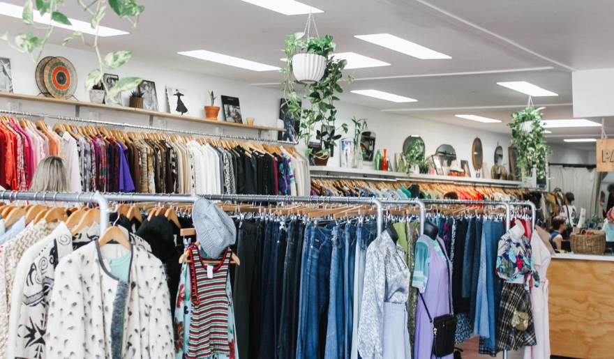 Interior of a clothing store at Barefoot Landing, showcasing clothes neatly arranged on racks and shelves.