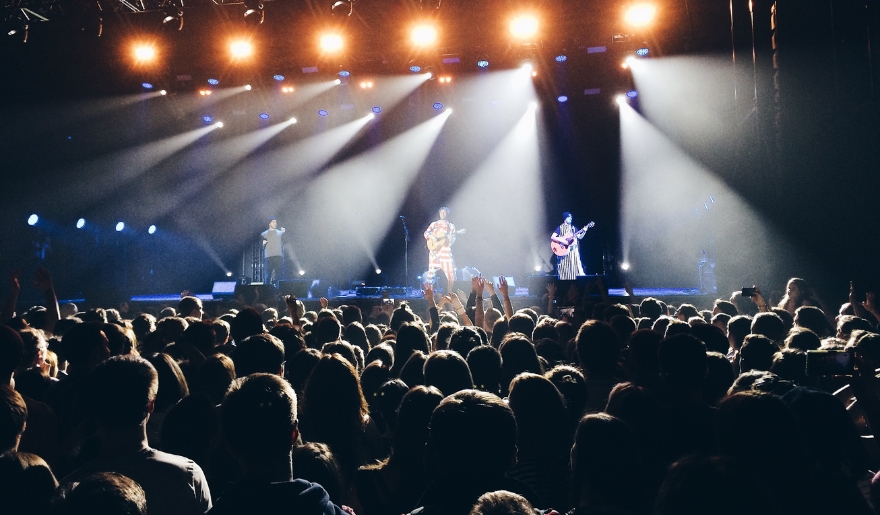 A lively concert scene at Myrtle Beach's Carolina Opry Show, featuring a large crowd and bright, colorful stage lights.