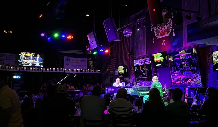 A lively crowd enjoying dinner at Crocodile Rocks in Myrtle Beach, seated at tables in a vibrant restaurant atmosphere.